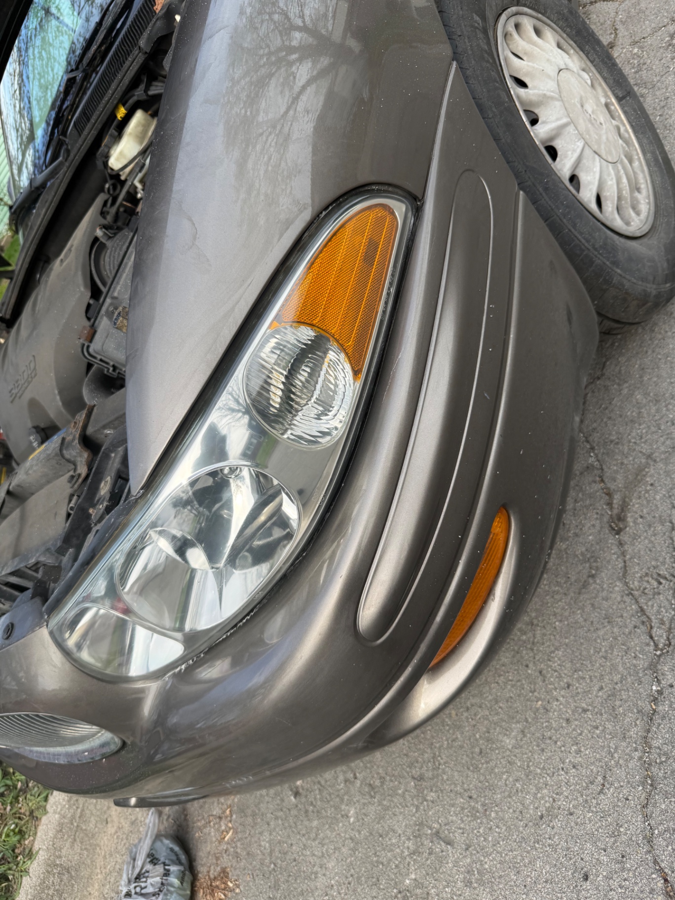 Same headlight assembly fully clear with a bright reflector after restoration